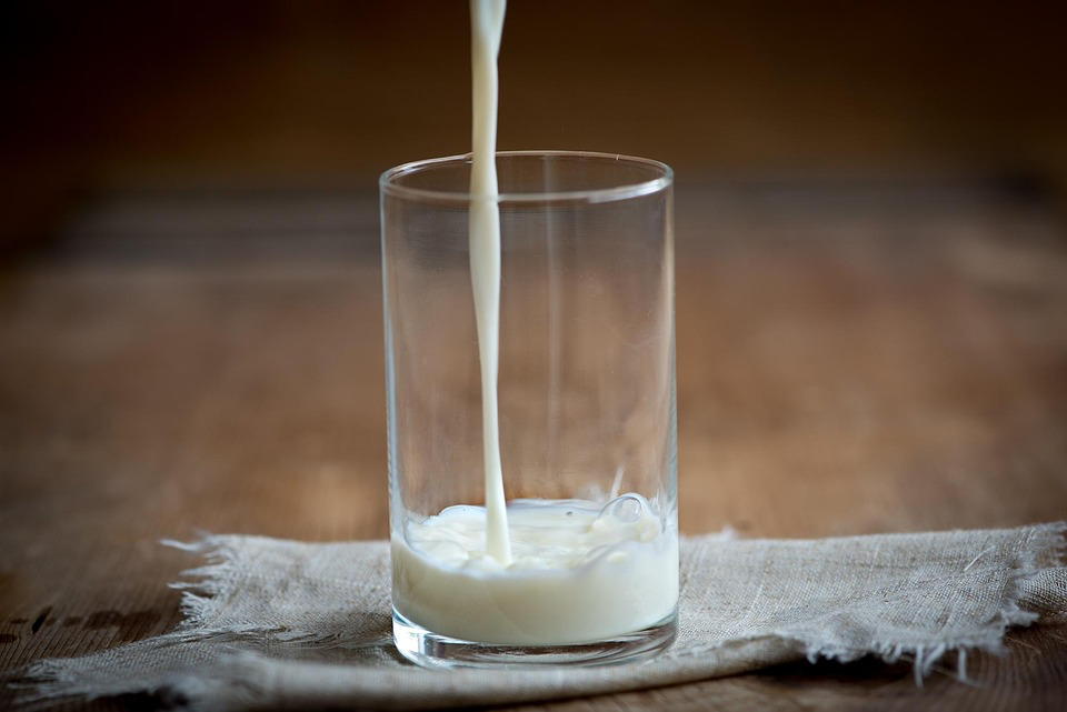 Milk being poured into a glass highlights the importance of calcium-rich beverages for bone health. Unlike soft drinks, milk provides essential nutrients that support strong bones, making it a healthier choice to promote overall skeletal well-being.