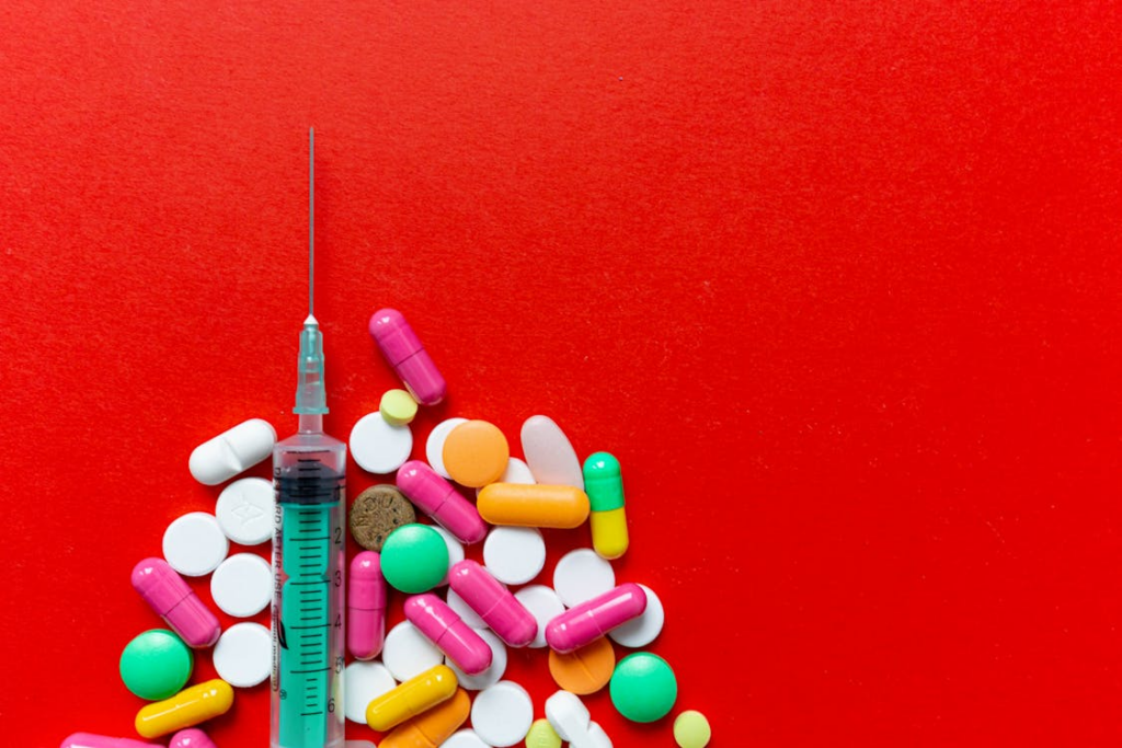 Close-Up of Pills and Syringe