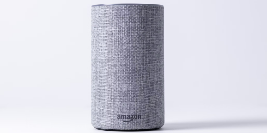 Gray Amazon Echo smart speaker shown against white background, representing the device at the center of Amazon Echo privacy concerns with its always-listening microphones that will soon transmit all voice data to cloud servers.