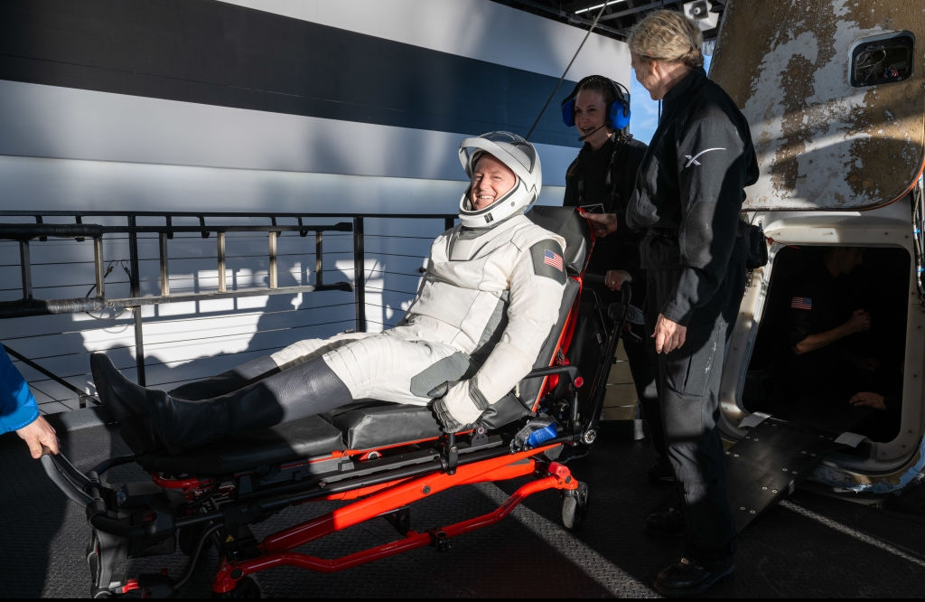 Barry 'Butch' Wilmore smiling and sitting in a stretcher after landing back on Earth.