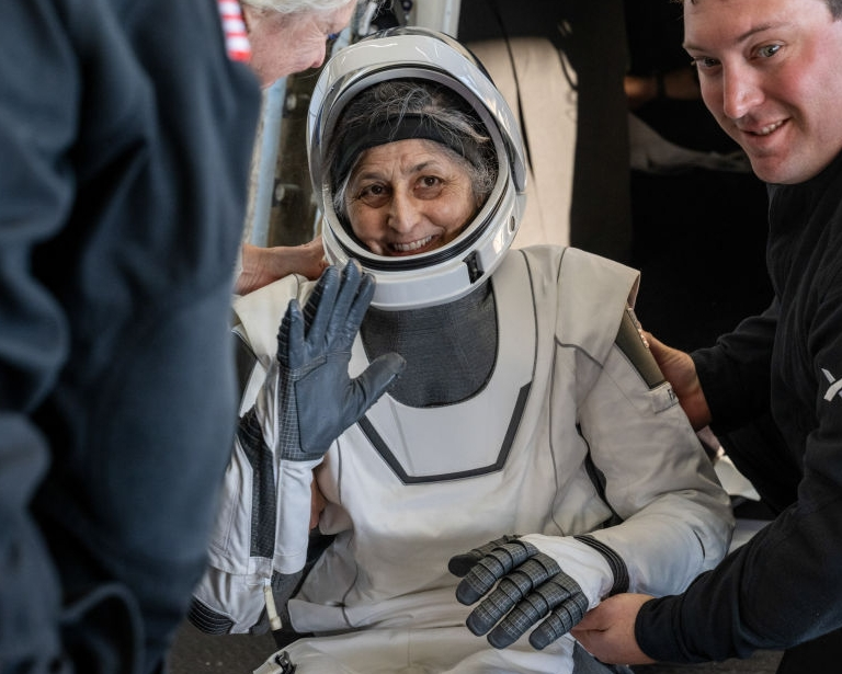 Suni Williams smiling and waving upon her return to Earth.