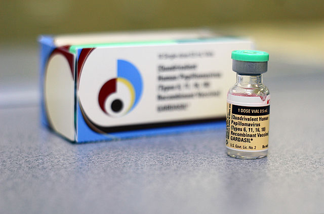 A small vial of the HPV vaccine placed on a table, showcasing its importance in health and prevention.