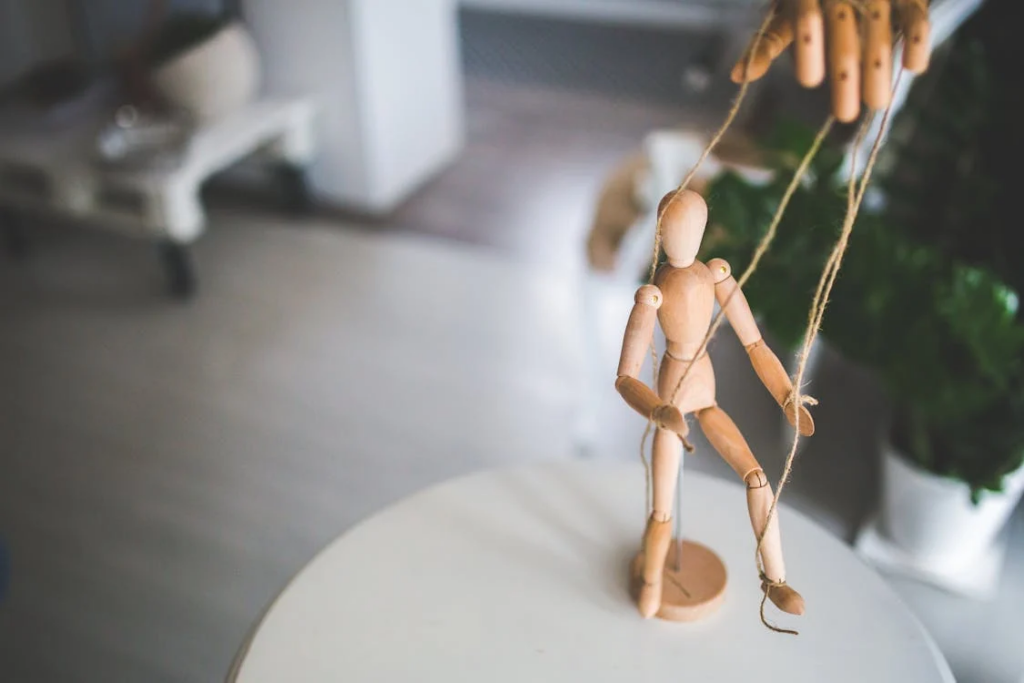 Wooden mannequin as a marionette