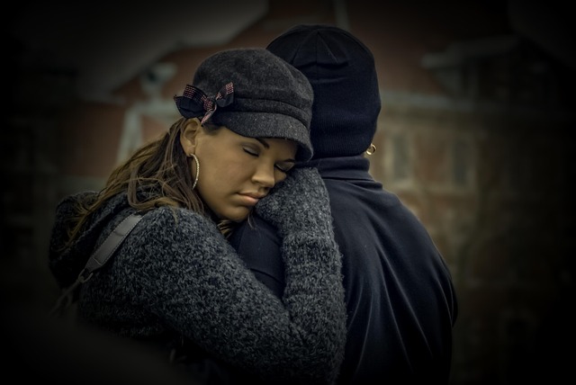tired woman resting on man's shoulder
