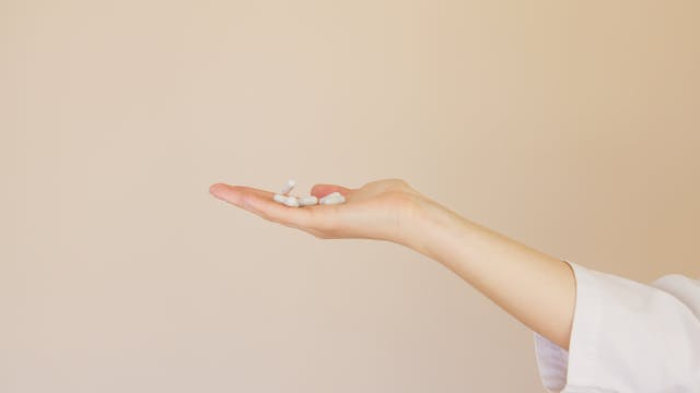 person holding supplements