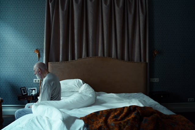 elderly person getting out of bed