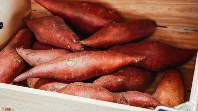 a crate of sweet potatoes