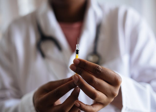 doctor holding a vaccine