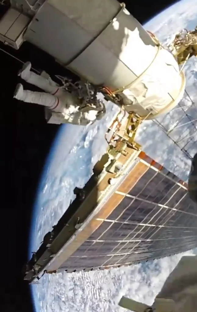 An image of a space satellite and part of the earth. 