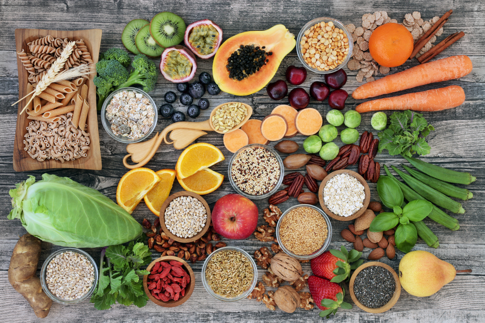 Vegan high dietary fibre and immune boosting health food with fruit, vegetables, whole wheat pasta, legumes, cereals, nuts and seeds with foods high in omega 3, antioxidants, anthocyanins, vitamins.
