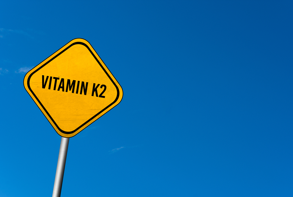 Vitamin K2 - yellow sign with blue sky
