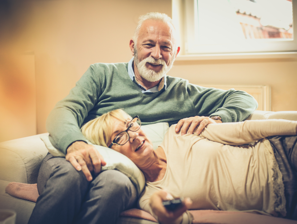 Young days can not be returned. Mature couple watching television.

