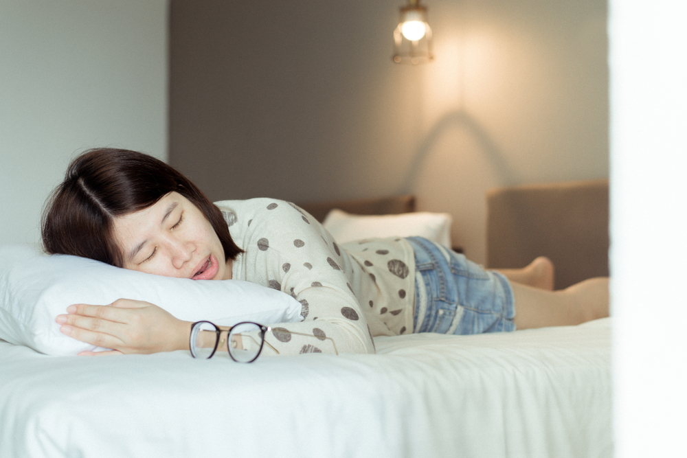 Asian woman snoring because due to tired of work,Female snore while sleeping open your mouth on bed