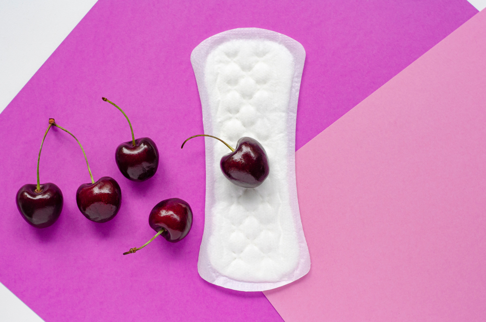 The concept of women's health. Gaskets. Vaginal discharge. Pink background. Red cherry.