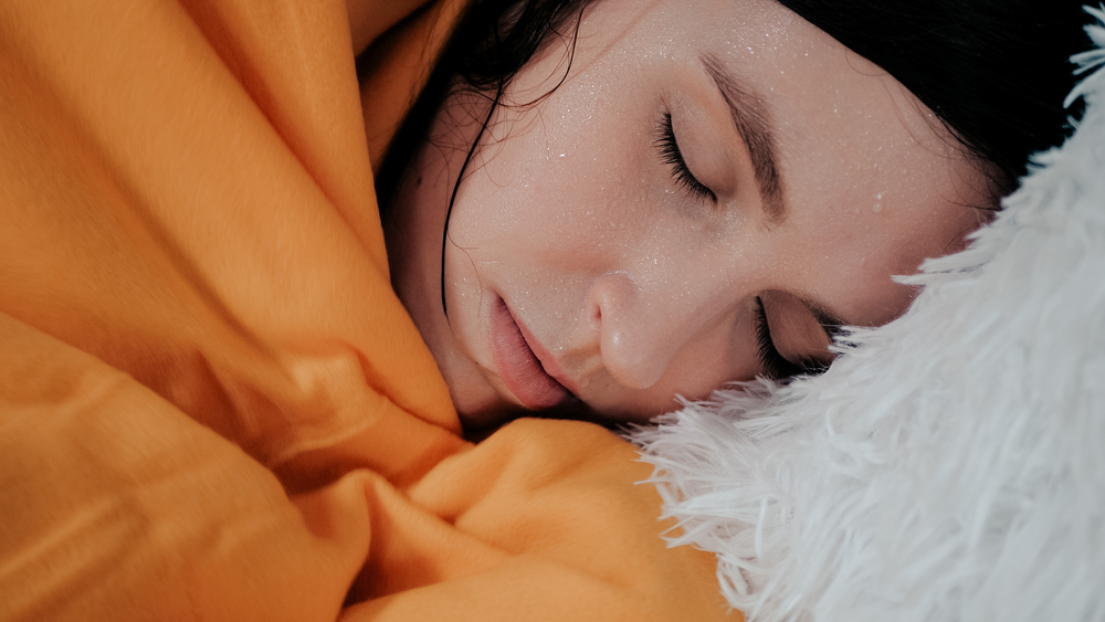 Sick ill Indian woman suffering from period cramps, painful stomach ache on sofa at home room. Girl holding belly, feeling abdominal menstrual pain. Abdominal pain, gastritis, diarrhea, indigestion
