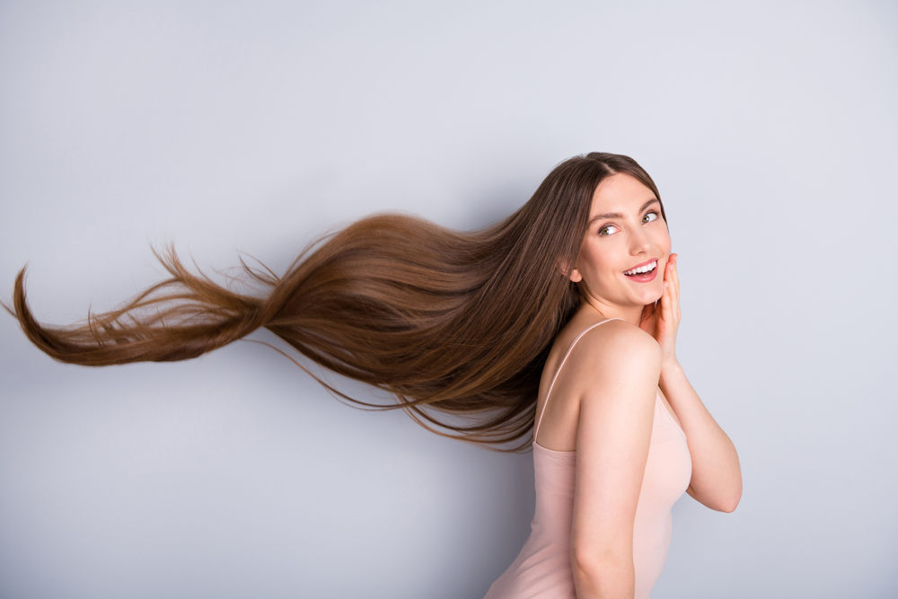 Profile photo of attractive cute model lady demonstrating ideal neat long healthy hairstyle flying on air after lamination procedure wear beige singlet isolated grey color background