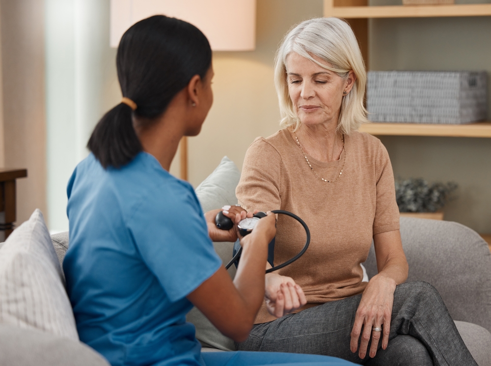 Lets hope my hypertension is under control. Shot of a doctor examining a senior woman with a blood pressure gauge at home.
