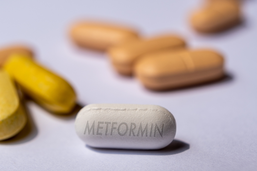 White Metformin Pill on Table with stethoscope and other tablets in background. Medicine used in standard oral therapy of type 2 diabetes in people who are overweight High Blood Sugar Treatment