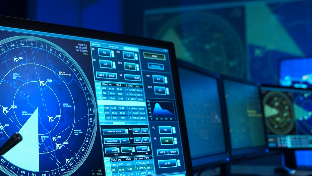 Workplace of the air traffic controllers in the control tower. Team of professional aircraft control officers works using radar, computer navigation and digital maps. Aviation concept.