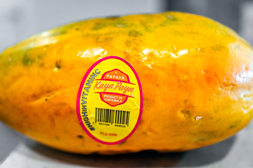 Calgary, Alberta, Canada. Jul 07, 2024.Close-up of a white sticker on a green mango. The sticker identifies the fruit from Mexico and lists a code.