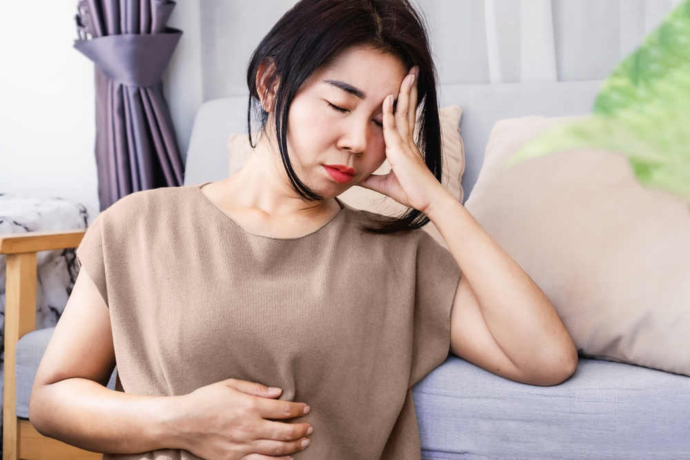Gut-Brain Axis and anxiety concept with stress Asian woman have problems with digestion systems, stomachache, irritable bowel syndrome ( IBS) 
