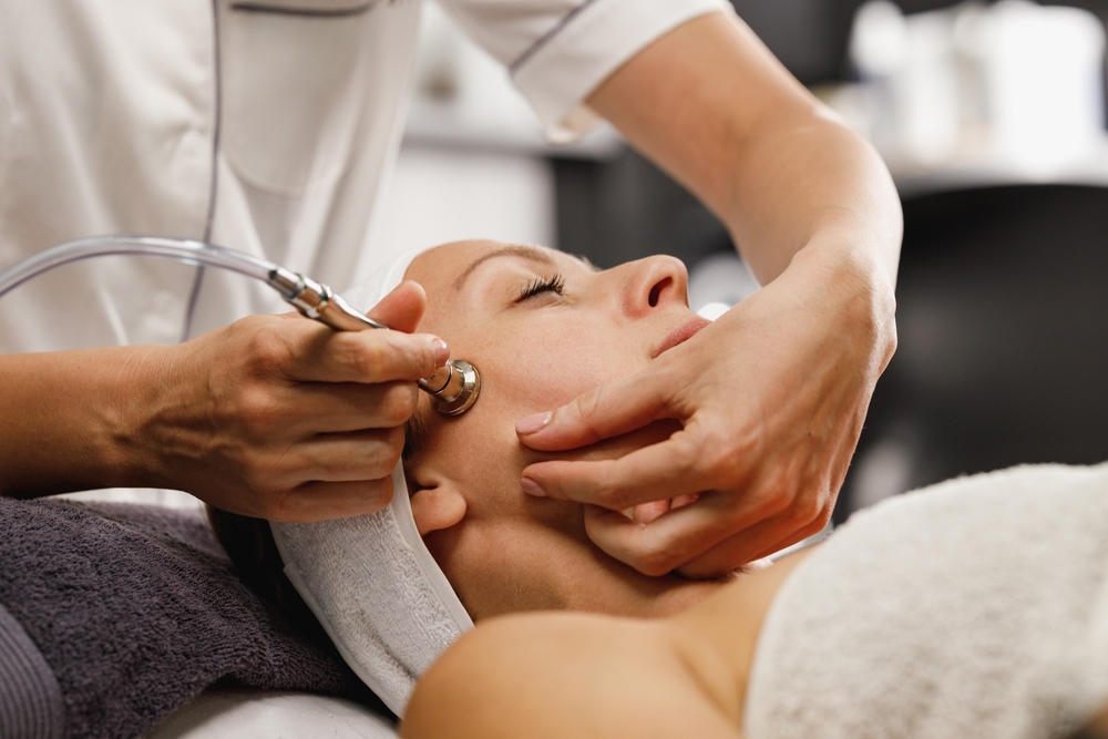 Shot of a beautiful mature woman on a microdermabrasion facial treatment at the beauty salon.
