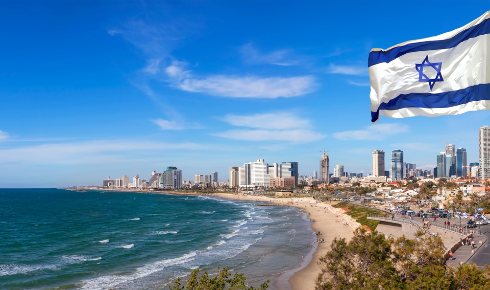Israeli National waving flag on Tel Aviv coast panoramic view background. Mediterranean, Middle East, Israel
