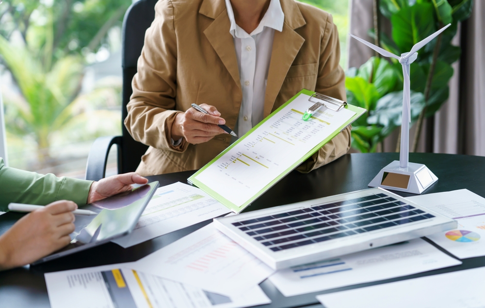 Solar panels green energy Business people working in green eco friendly office business meeting creative ideas for business eco friendly professional teaching corporate people sustainable electricity
