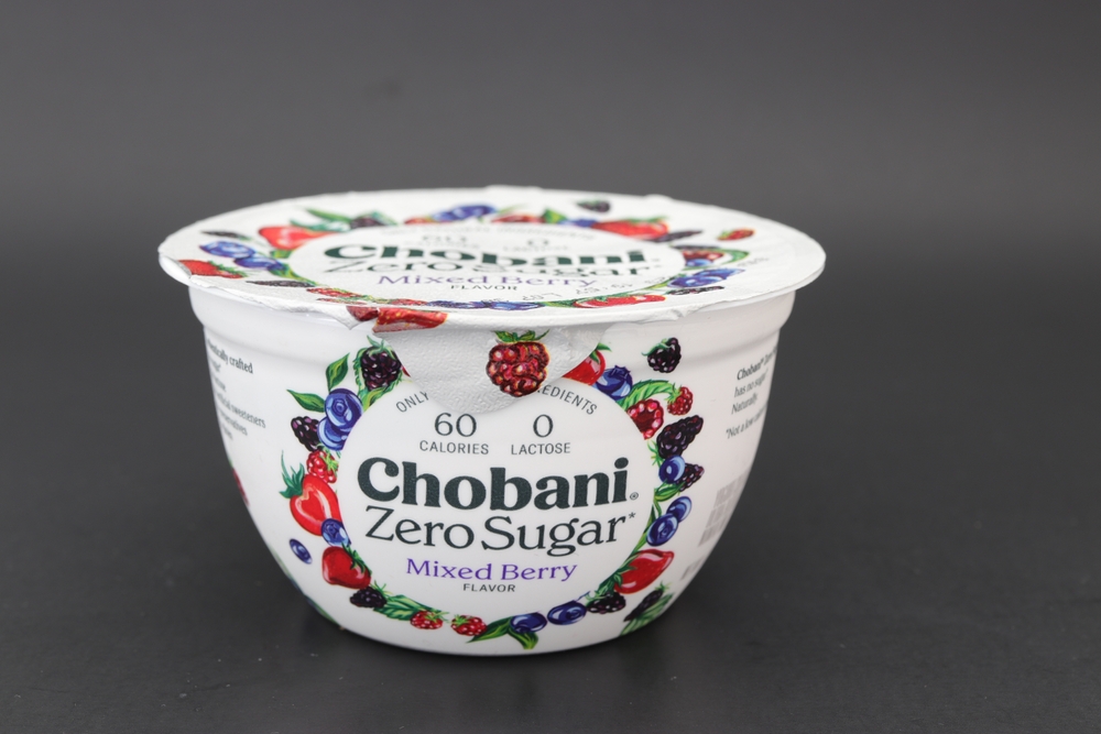 MIAMI, FLORIDA USA - 08-25-2023 Chobani zero sugar yogurt isolated against dark background.