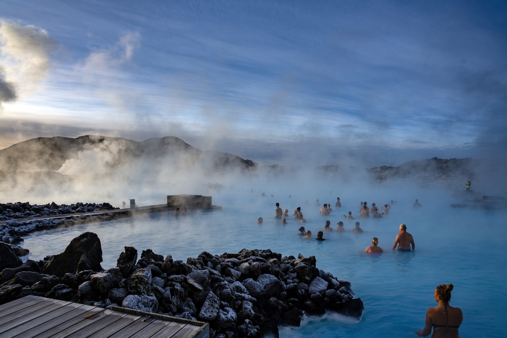 GRINDAVIK, ICELAND - MARCH 9, 2023: People swimming in the Blue Lagoon Geothermal bath in winter time. The Blue Lagoon spa is one of the most visited attractions in Iceland.
