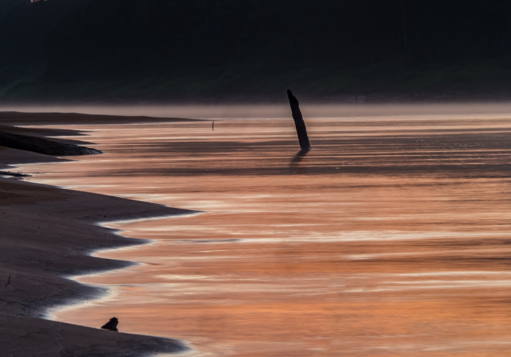 Sunrise over the Javarii river, tributary of the Amazon. Sandy beach in Amazon jungle, during the low water season. Amazonia. Selva on the border of Brazil and Peru. South America. Dos Fronteras.