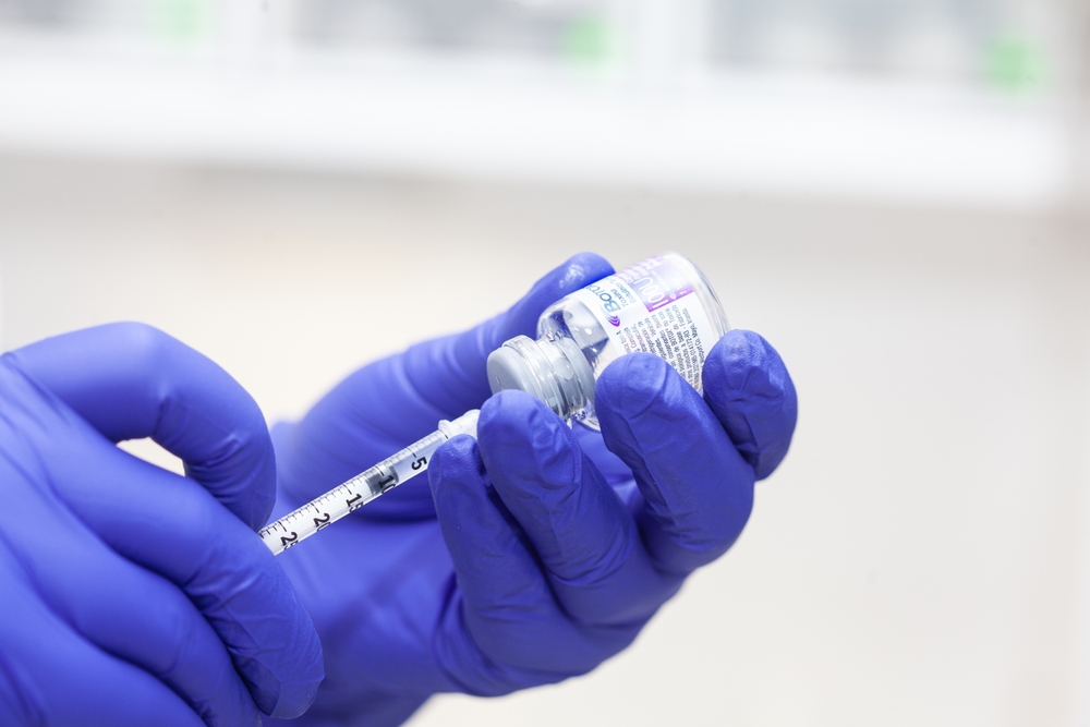 Cali, Colombia - July 12, 2024: Hands of a dermatologist with a Botox bottle during the application of Botulinum toxin injection to a patient. Aesthetic medicine.