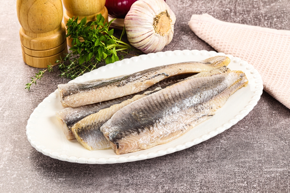 Marinated salted herring fillet apetizer with oil