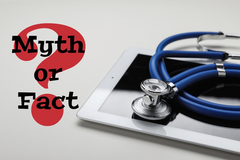 Medical myths. Tablet and stethoscope near question mark with words on white background
