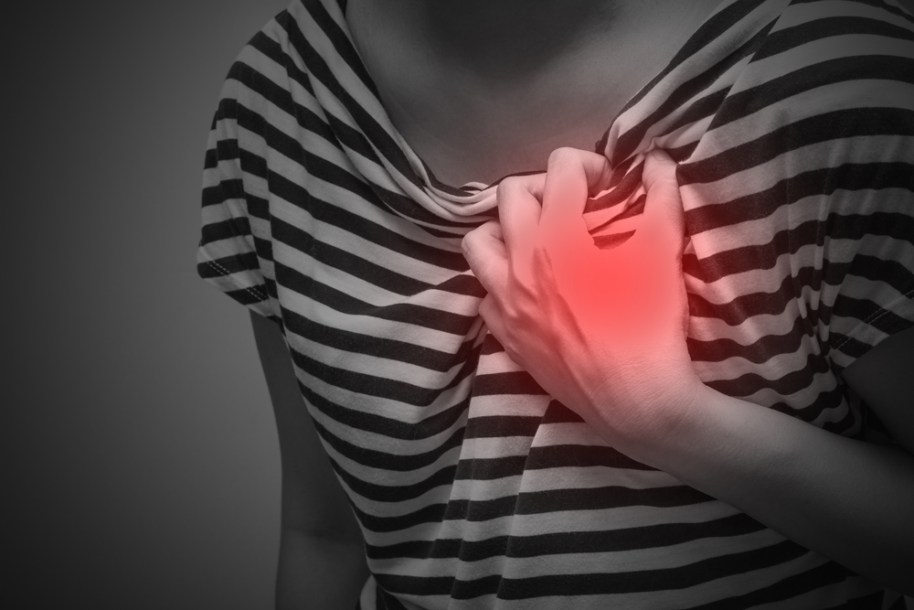 Sick woman with severe heartache, suffering from chest pain
