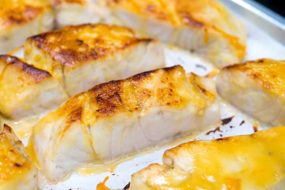 sea bass grilled on hot pan served with miso sauce, close up