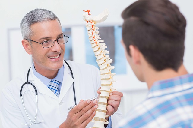 doctor showing patient spinal cord injury