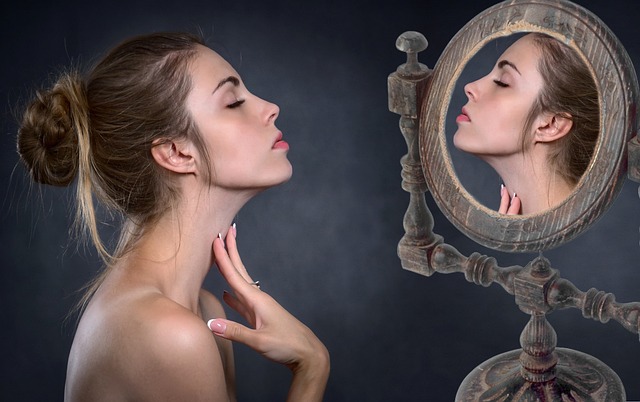 woman looking at neck in the mirror