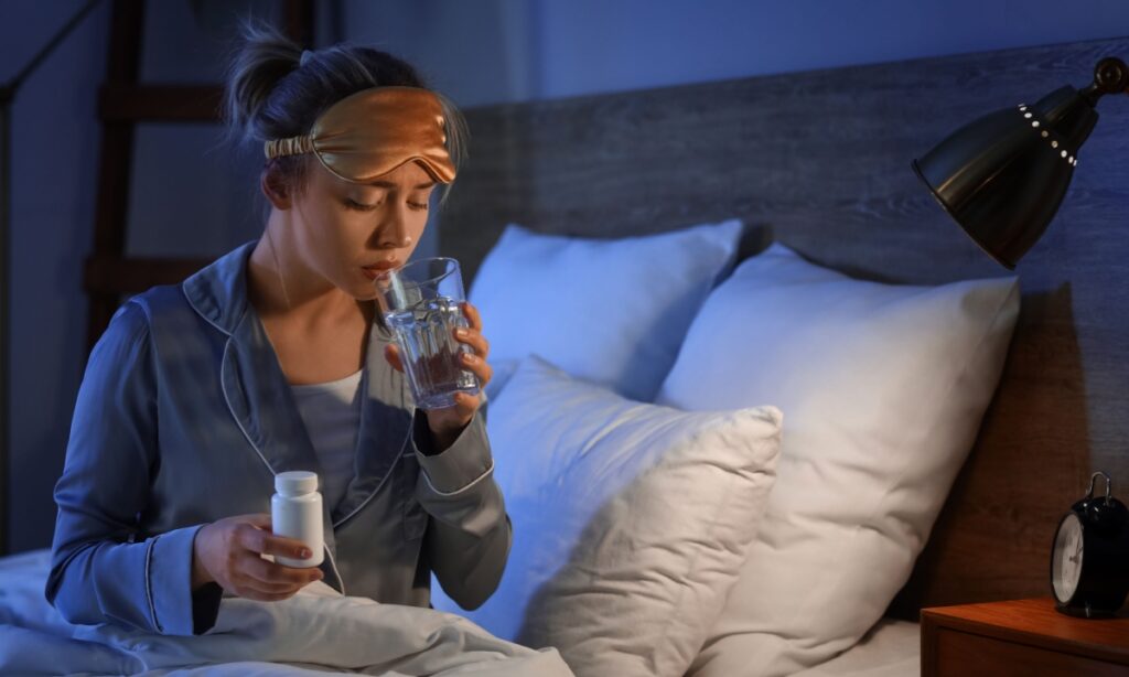 woman drinking water at night