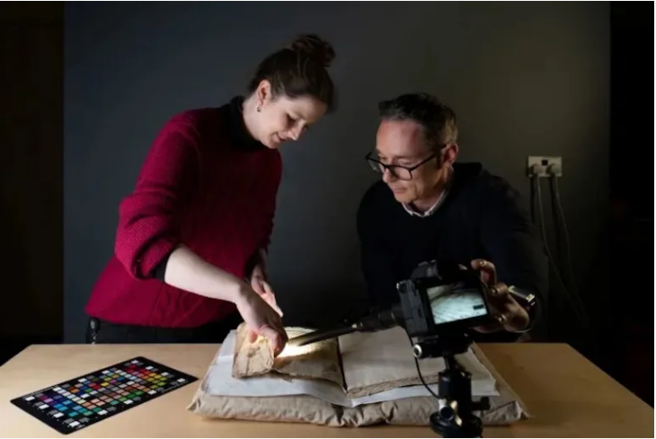 Sally Kilby (Conservation Department) and Błażej Mikuła (CHIL) carefully photograph inside the folds of the manuscript