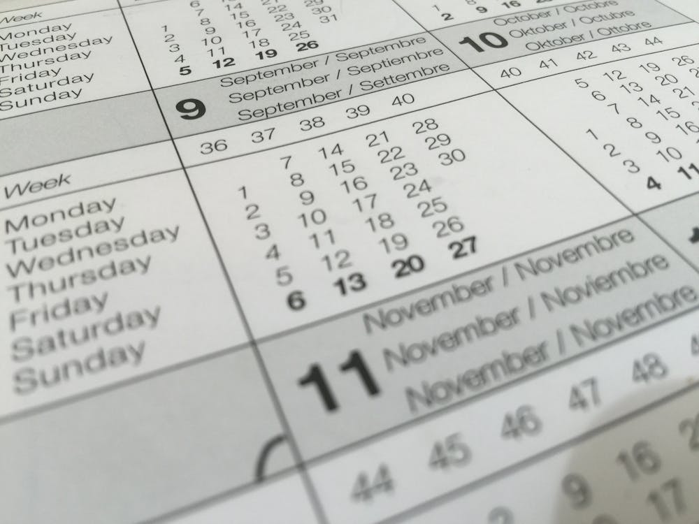 Close-up of a printed calendar showing September, October, and November with clearly marked dates and weekdays. The calendar represents the passage of time that families track after a dementia diagnosis, highlighting the importance of planning and maintaining routines throughout the journey.