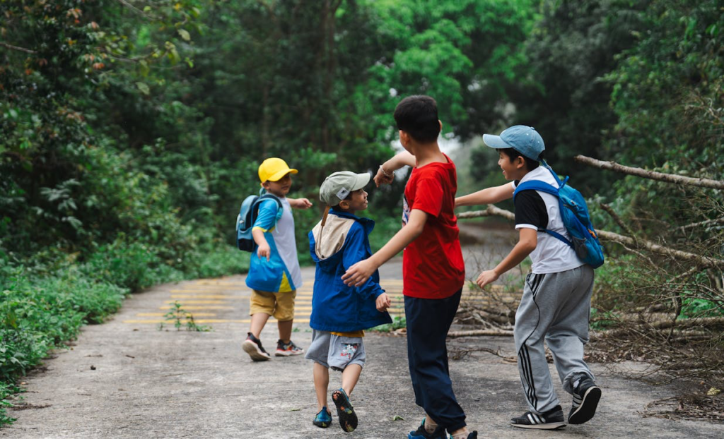 Group of children exploring nature independently, illustrating Gates' concern about balancing protection with the freedom needed to develop problem-solving skills that will help address threats to younger generations.