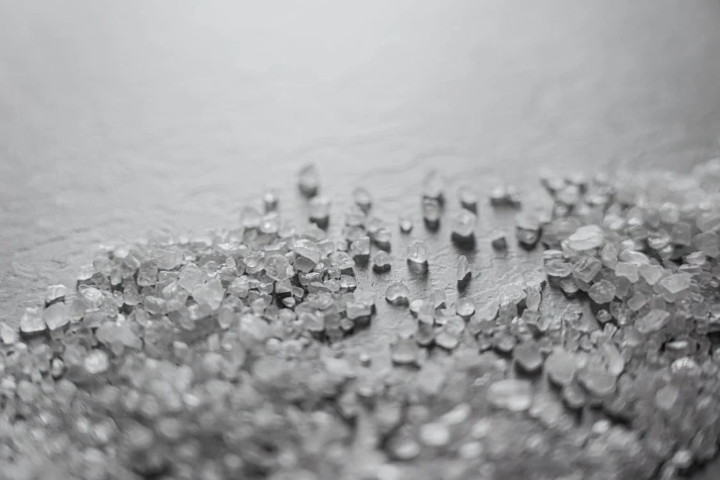 Close-up of salt crystals on a white surface.