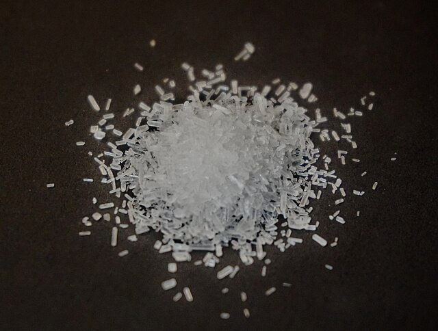 Crystalline pile of MSG (monosodium glutamate), a flavor enhancer used in instant ramen noodles that may cause adverse reactions in some people.