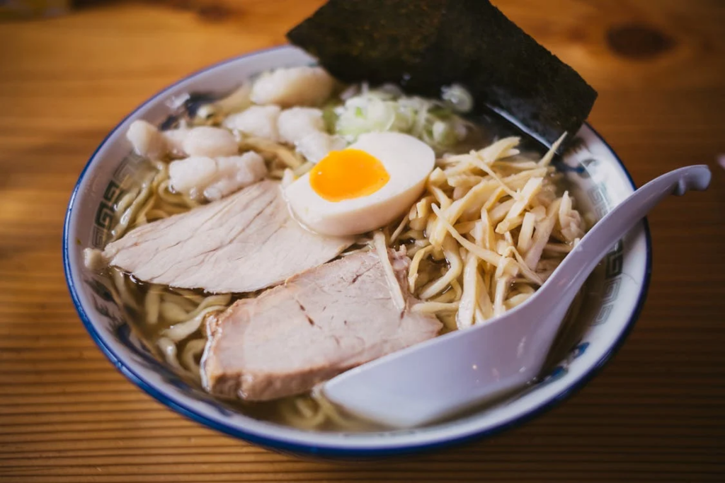 Healthy ramen noodle bowl with eggs, vegetables, and protein toppings.