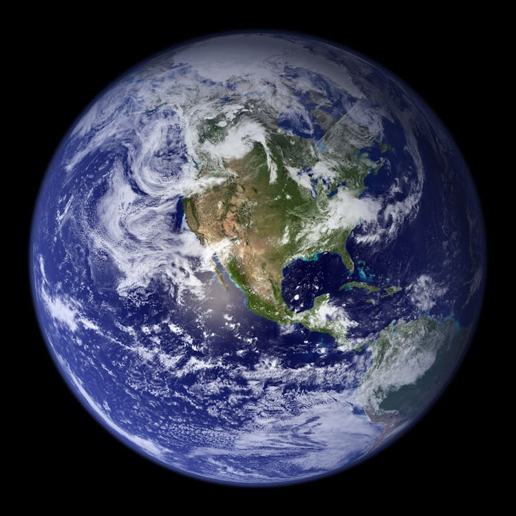 A NASA photograph known as the "Blue Marble" showing Earth as a perfect sphere that would leave any flat earther speechless. The image displays the entire planet against the blackness of space, clearly showing North America, Central America, and parts of South America. The Earth's blue oceans, white cloud patterns, and green and brown landmasses are visible in stunning detail. The photograph captures Earth's undeniable spherical shape from space, making it one of the most iconic and compelling images demonstrating our planet's true form.
