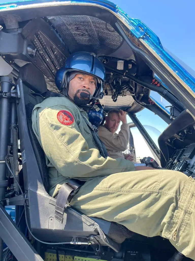 Pilot Sean Johnson seen in uniform,  sitting inside a helicopter .