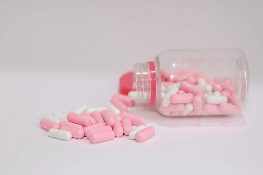 Pink and White Pills Spilled from a Bottle