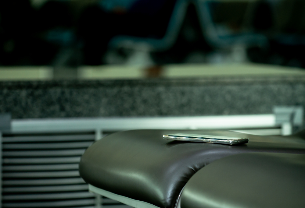 Smartphones forgotten on the seat,Mobile phone put forgotten ,Smartphone with an on the seat of a high-speed train,Concept of mobile communication in travel and lost gadgets,Copy space,
