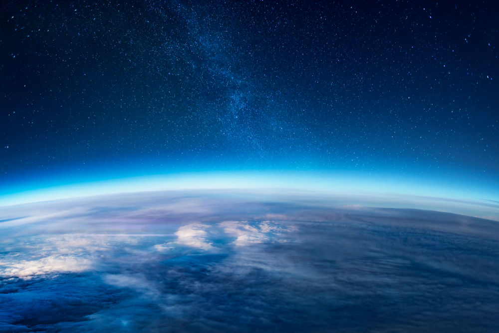 View of stars and milkyway above Earth from space